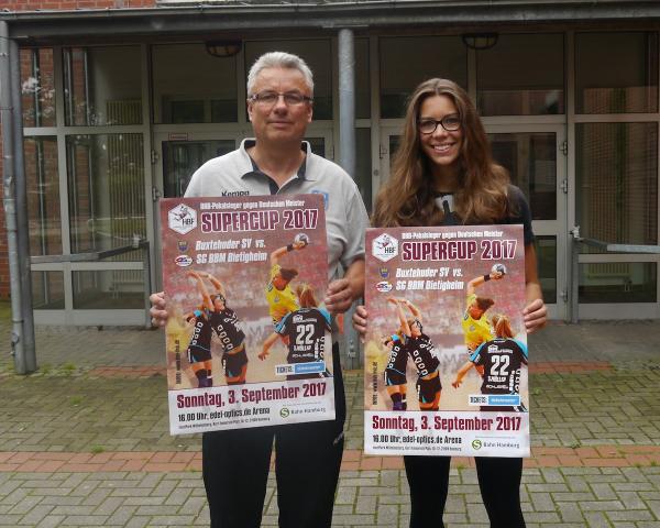 Buxtehudes Trainer Dirk Leun und Emily Bölk mit den Supercup-Plakaten